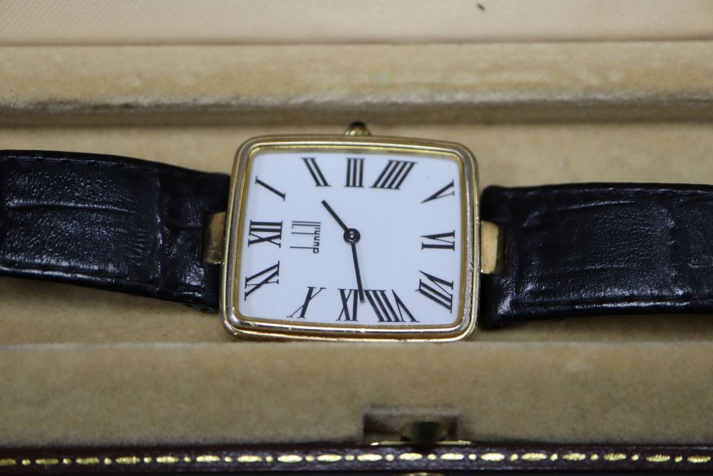 A gentlemans stylish modern silver gilt Dunhill quartz wrist watch, with rectangular Roman dial, on leather strap, with Dunhill buckle